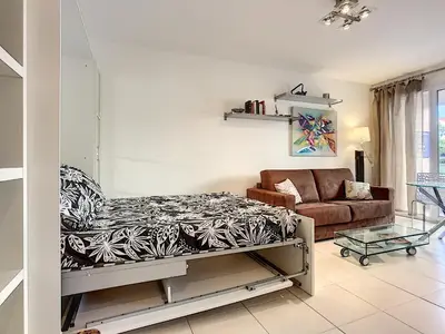 a living room with a bed and a couch at Nicolas 8 in Cannes