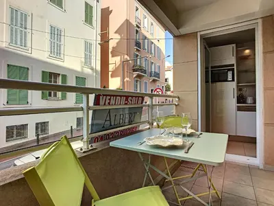 a balcony with a table and chairs on a balcony at Nicolas 8 in Cannes