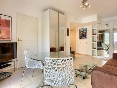 a living room with a glass table and chairs at Nicolas 8 in Cannes