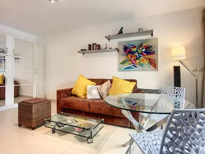 a living room with a couch and a glass table at Nicolas 8 in Cannes