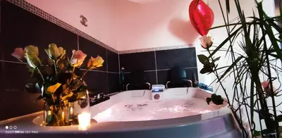 a bathroom with a tub with flowers and a balloon at CANNES TOIT ET MOI in Cannes