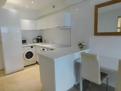 a white kitchen with a washing machine and a washer at Lovely 1 Bedroom Boulevard de la Croisette in Cannes
