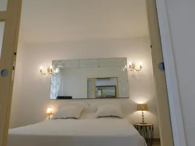 a bedroom with a white bed and a mirror at Lovely 1 Bedroom Boulevard de la Croisette in Cannes