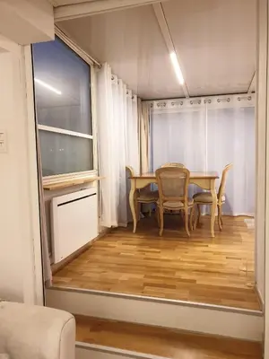a dining room with a table and chairs and a window at Lovely 1 Bedroom Boulevard de la Croisette in Cannes