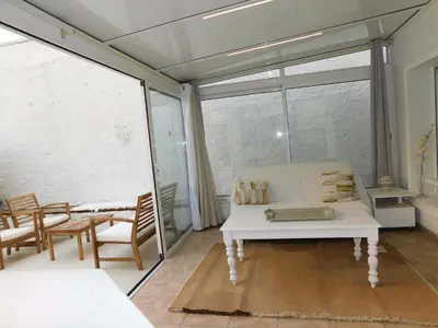 a living room with a white couch and a large window at Lovely 1 Bedroom Boulevard de la Croisette in Cannes