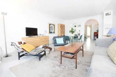 a living room with a couch and a table at Palm Beach Amazing view in Cannes