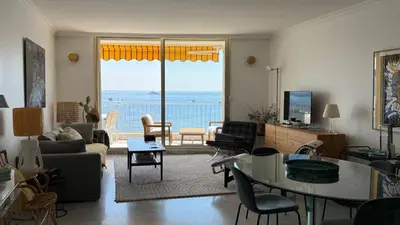 a living room with a view of the ocean at Palm Beach Amazing view in Cannes