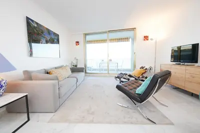 a living room with a couch and a tv at Palm Beach Amazing view in Cannes