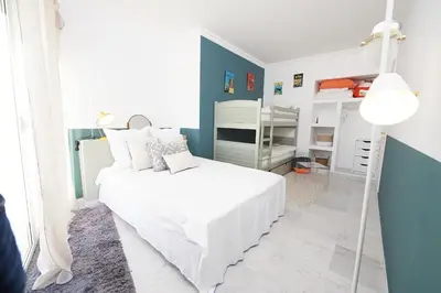 a bedroom with a white bed and a blue wall at Palm Beach Amazing view in Cannes