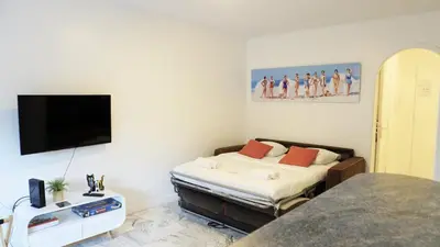 a bedroom with a bed and a flat screen tv at Proche Croisette, Exclusivité Congres by Palmazur in Cannes