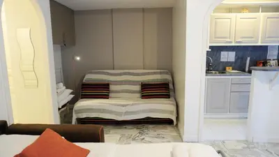 a living room with a bed and a kitchen at Proche Croisette, Exclusivité Congres by Palmazur in Cannes