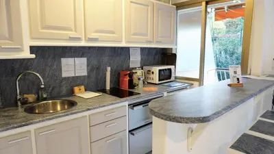 a kitchen with white cabinets and a sink at Proche Croisette, Exclusivité Congres by Palmazur in Cannes