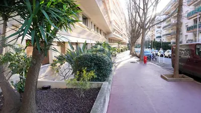 a sidewalk with trees and a red fire hydrant next to a building at Proche Croisette, Exclusivité Congres by Palmazur in Cannes