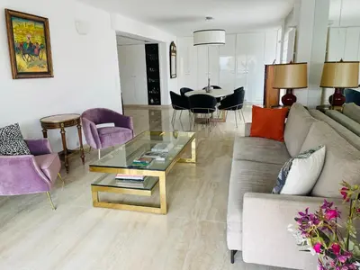 a living room with a couch and a table at Appartement privé vue mer Cannes centre Gray d'Albion in Cannes