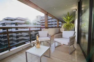 a balcony with two chairs and a table at Appartement privé vue mer Cannes centre Gray d'Albion in Cannes