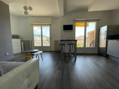 a living room with a couch and a table and chairs at Le Maria - Cannes - Renovated Feb 2025 in Cannes