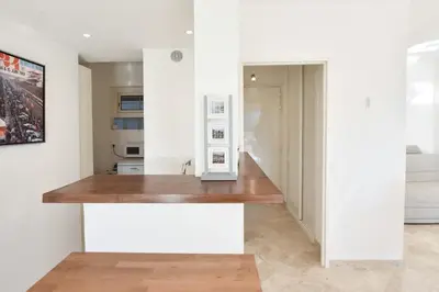 a kitchen with white walls and a wooden counter top at 1-Br Sea view Luxury Residential with pool in Cannes