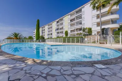 a swimming pool in front of a building at 1-Br Sea view Luxury Residential with pool in Cannes