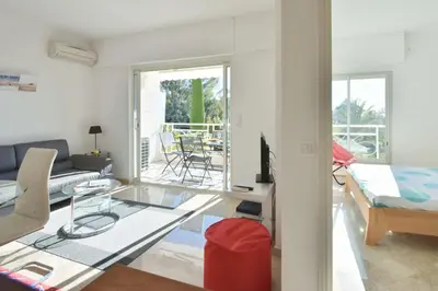 a living room with a glass table and a couch at 1-Br Sea view Luxury Residential with pool in Cannes