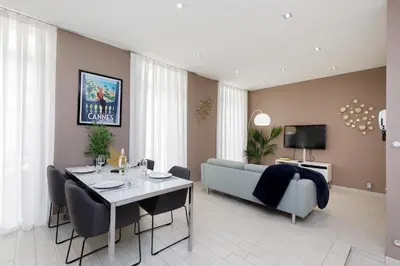 a living room with a table and a couch at beautiful 3 room-flat near palais in Cannes