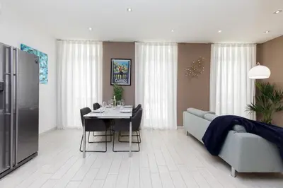 a living room with a table and a couch at beautiful 3 room-flat near palais in Cannes