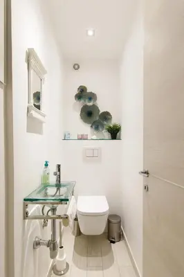 a bathroom with a toilet and a sink at beautiful 3 room-flat near palais in Cannes