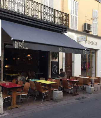 a group of tables and chairs in front of a restaurant at beautiful 3 room-flat near palais in Cannes