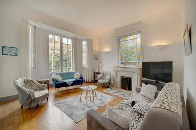 a living room with a couch and chairs and a fireplace at IMMOGROOM - Villa in the city center with terrace- garden in Cannes