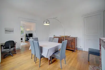 a dining room with a white table and chairs at IMMOGROOM - Villa in the city center with terrace- garden in Cannes