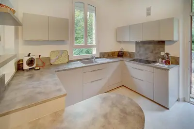 a kitchen with white cabinets and a sink at IMMOGROOM - Villa in the city center with terrace- garden in Cannes