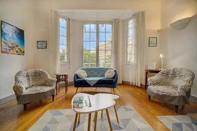 a living room with two chairs and a couch at IMMOGROOM - Villa in the city center with terrace- garden in Cannes