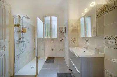 a white bathroom with a sink and a shower at IMMOGROOM - Villa in the city center with terrace- garden in Cannes