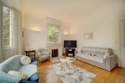 a living room with a couch and a fireplace at IMMOGROOM - Villa in the city center with terrace- garden in Cannes