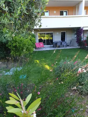 a house with a yard with flowers and plants at Appartement duplex 6 personnes Cannes Grand Parc in Cannes