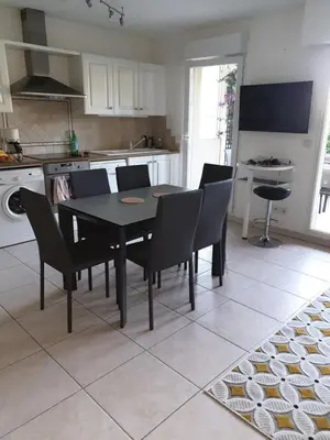 a kitchen with a dining room table and chairs at Appartement duplex 6 personnes Cannes Grand Parc in Cannes