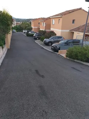 an empty street with cars parked in a driveway at Appartement duplex 6 personnes Cannes Grand Parc in Cannes
