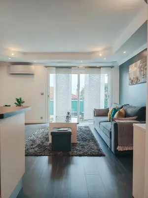 a living room with a couch and a table at Magnifique appartement le Cannet,Cannes, Parking, Wifi in Le Cannet