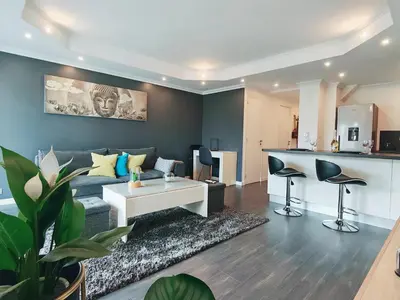 a living room with a couch and a table at Magnifique appartement le Cannet,Cannes, Parking, Wifi in Le Cannet
