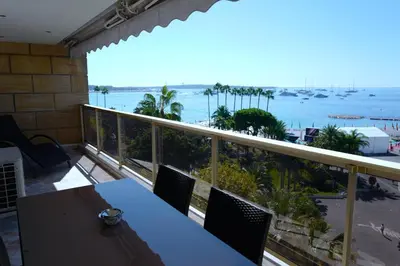 a balcony with a table and a view of the ocean at Cannes - Croisette - Palais des Festivals in Cannes