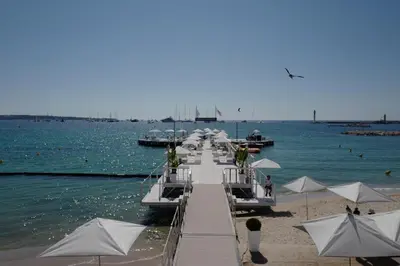 a group of boats are docked on the beach at Cannes - Croisette - Palais des Festivals in Cannes