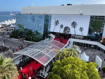 a crowd of people on a red carpet in front of a building at Cannes - Croisette - Palais des Festivals in Cannes