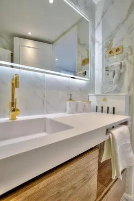 a white bathroom with a sink and a mirror at Luxury 4 Stars Apartment with 2 Terraces, Cannes Croisette in Cannes