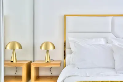 a bedroom with a bed and two lamps on tables at Luxury 4 Stars Apartment with 2 Terraces, Cannes Croisette in Cannes