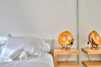 a bedroom with a bed with two egg incubators on night stands at Luxury 4 Stars Apartment with 2 Terraces, Cannes Croisette in Cannes