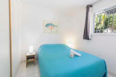 a bedroom with a blue bed and a window at Villa Francia in Cannes