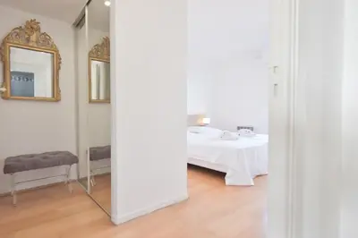 a white room with a table and a mirror at 3-Br Apartment Sea View Swimming Pool in Cannes