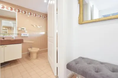 a bathroom with a sink and a toilet and a mirror at 3-Br Apartment Sea View Swimming Pool in Cannes