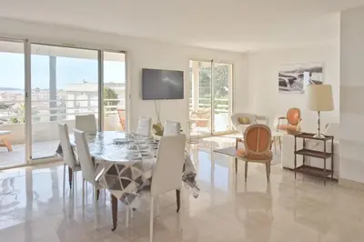a dining room with a table and chairs at 3-Br Apartment Sea View Swimming Pool in Cannes