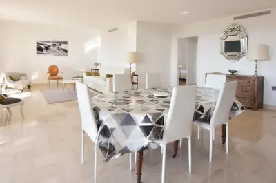 a dining room with a table and chairs at 3-Br Apartment Sea View Swimming Pool in Cannes