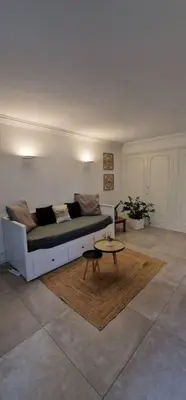 a living room with a couch and a coffee table at Le Castille - à deux pas des plages in Cannes